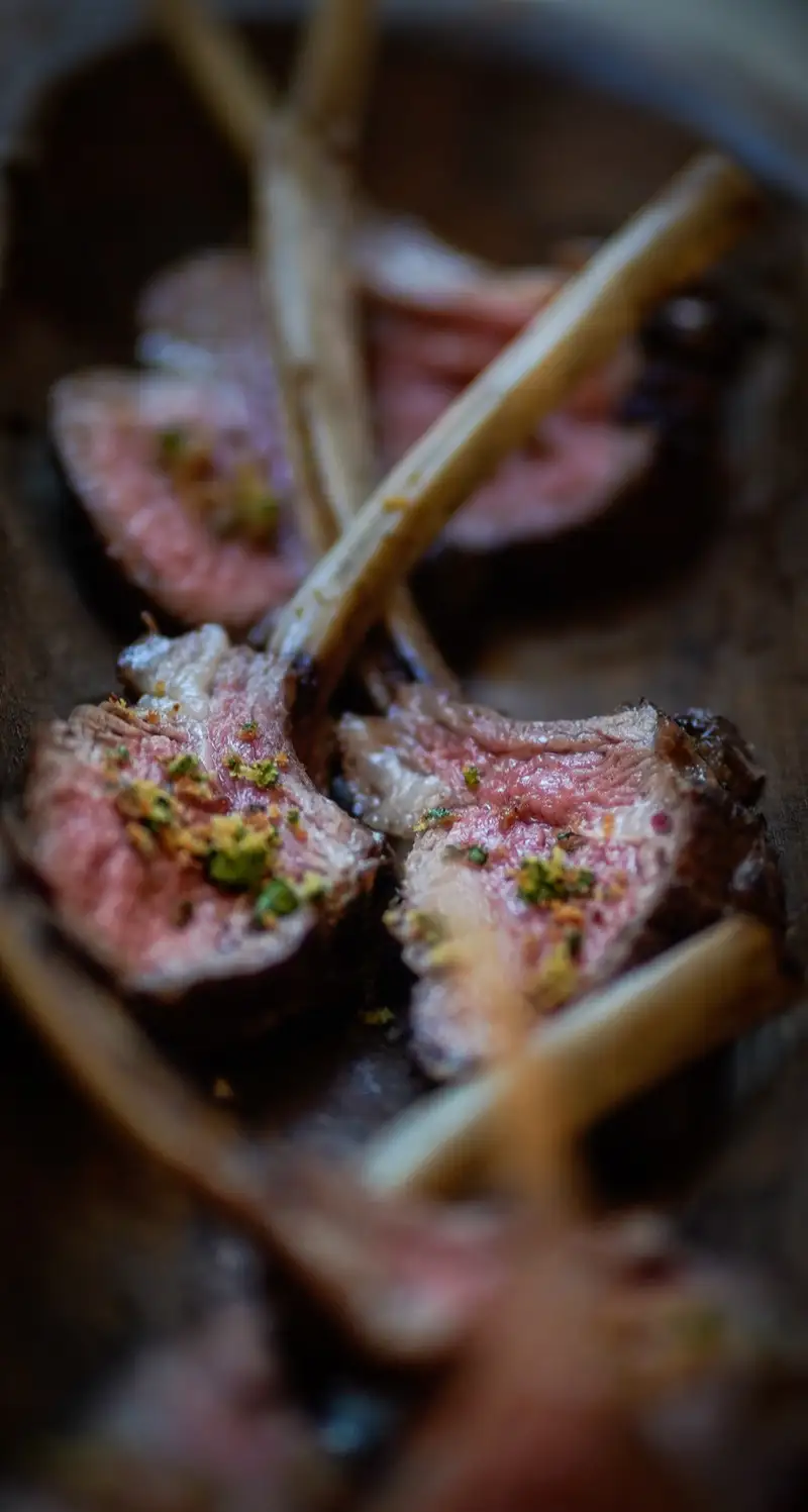 Rack of lamb chops seared rare, garnished with gremolata